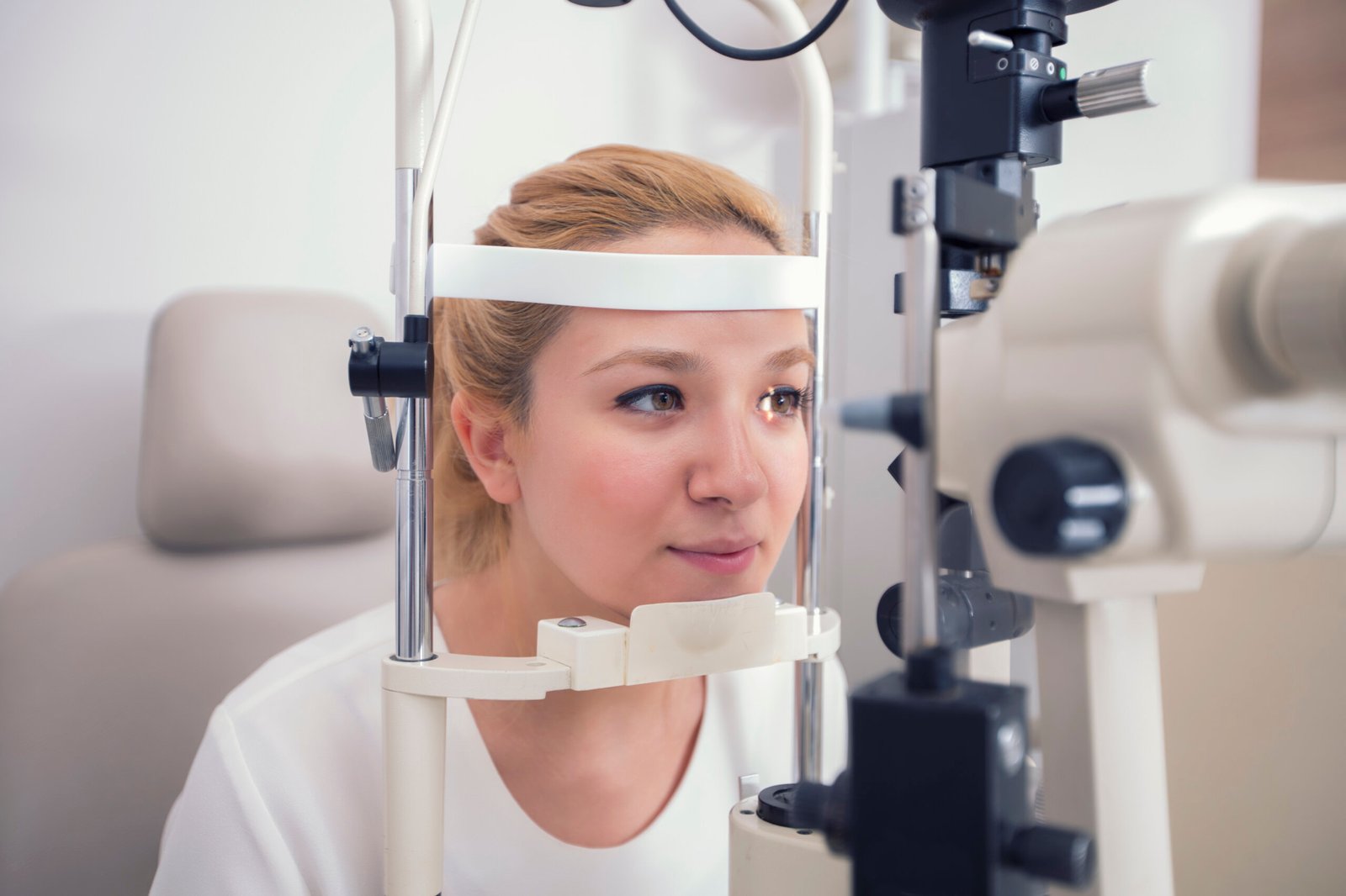 pole-ophtalmologie-colombes-la-defense patiente bénéficiant d'une trabéculoplastie par laser slt assisse devant l'appareil